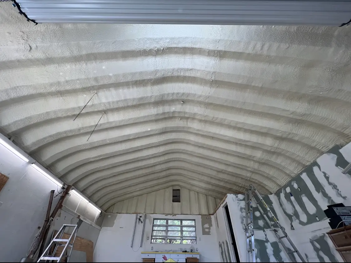 Spray polyurethane foam applied to the underside of a metal roof deck in East End